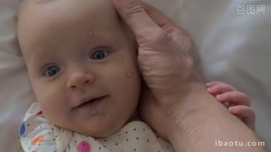 特写镜头慈爱的父亲轻轻地抚摸婴儿的头可爱的蓝眼睛的孩子微笑